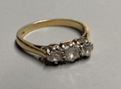 A mid 20th century 18ct and three stone diamond ring, size K/L, gross 2.7 grams.CONDITION: Some