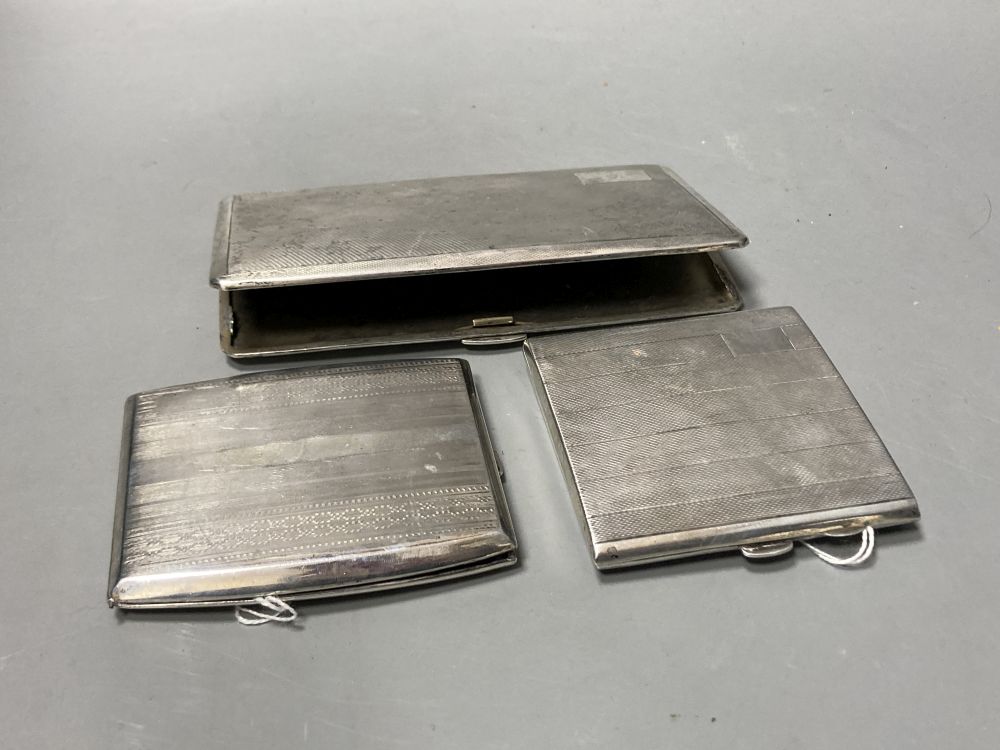 Three engine-turned silver cigarette cases, various, two with English hallmarks, one inscribed to