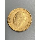 A George V 1911 gold sovereign, GVF.