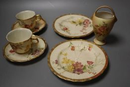 A Royal Worcester over-handled vase painted with flower on a blush ivory ground and two Royal