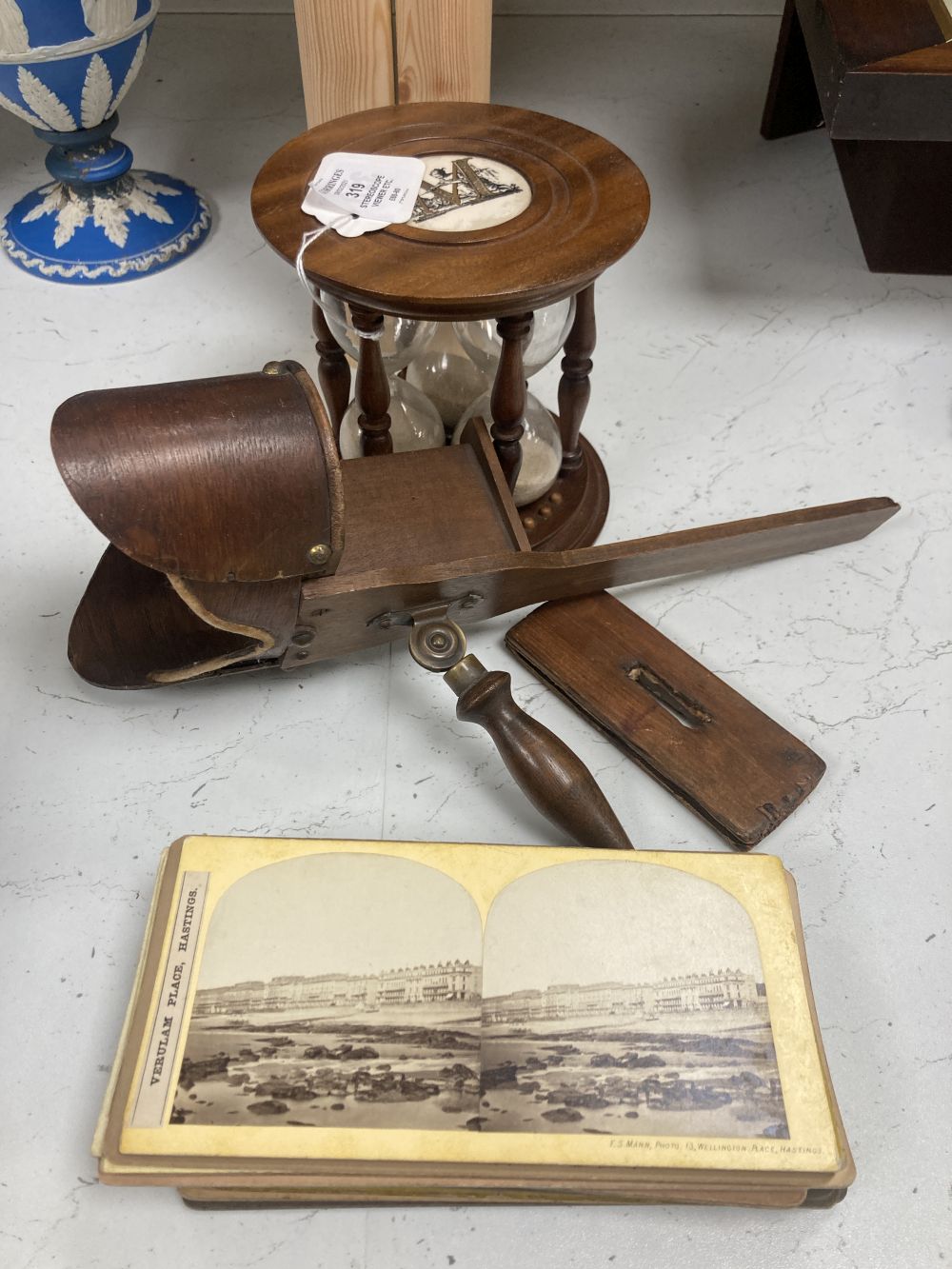 A stereoscope viewer with slides and a sand timer