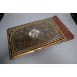 An Iranian photograph album, front and back covers with elaborate mounts, 17 x 10in.