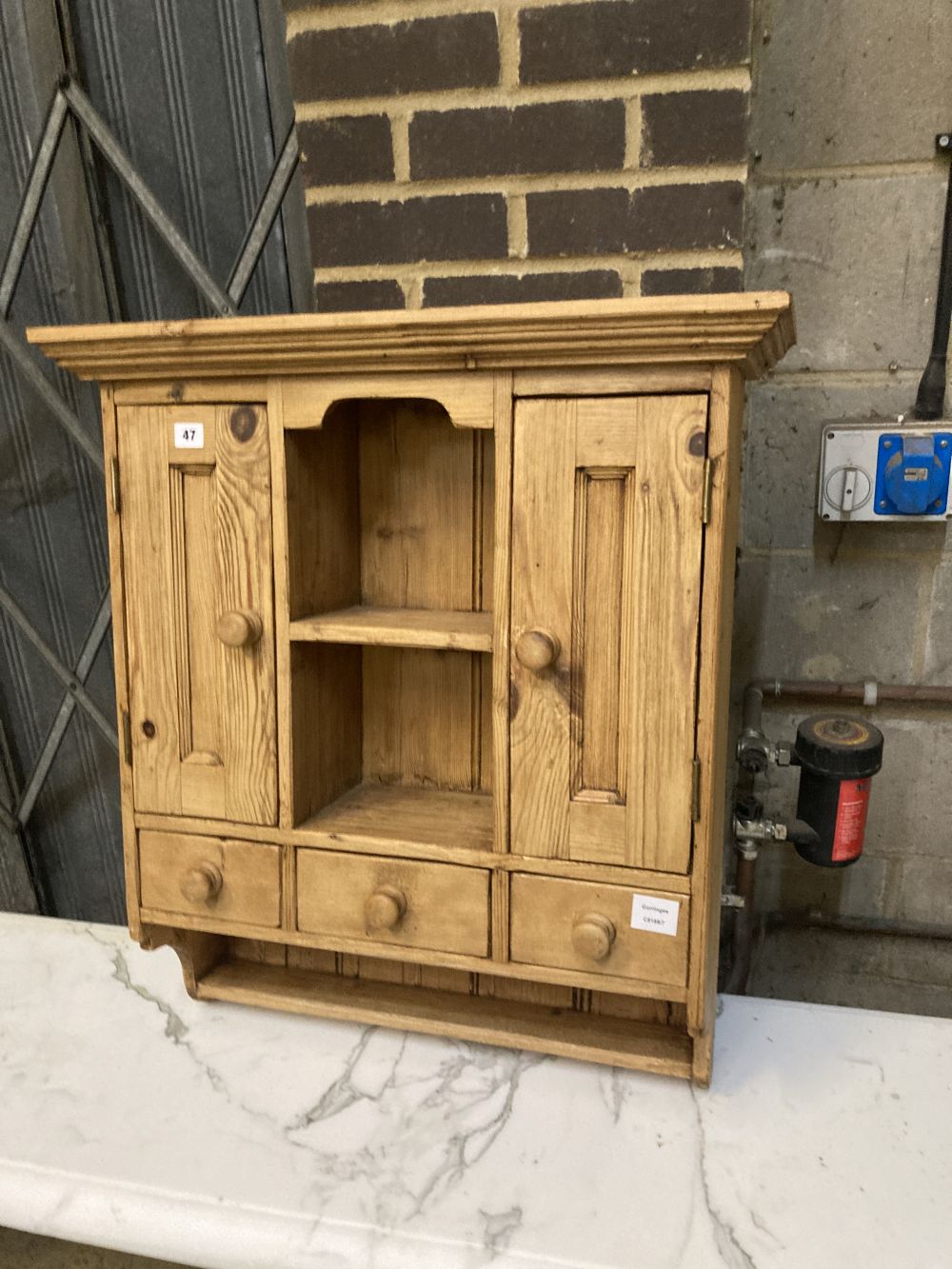 A small pine cabinet, width 69cm depth 23cm height 77cm