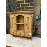 A small pine cabinet, width 69cm depth 23cm height 77cm