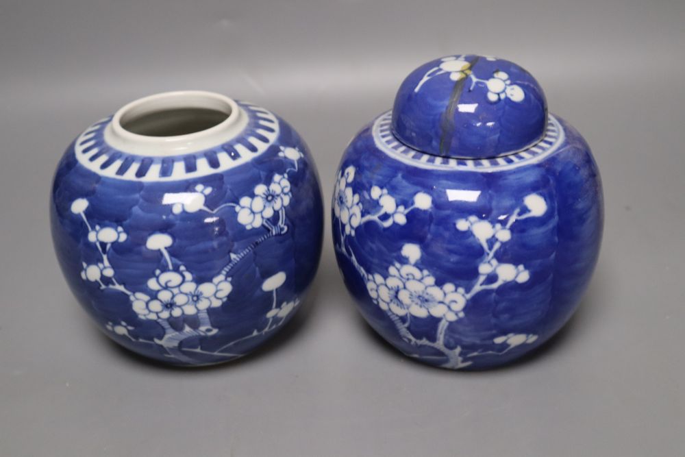 Two Chinese prunus pattern jars, one with a repaired cover, 14cm