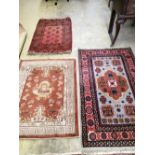 A Caucasian design rug, 150 x 94cm together with a smaller Chinese rug and a small Bokhara rug