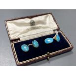 A pair of yellow metal and oval turquoise cabochon set cufflinks, stone length approx. 12mm, gross