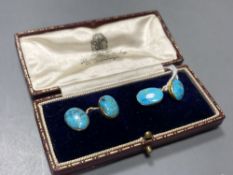 A pair of yellow metal and oval turquoise cabochon set cufflinks, stone length approx. 12mm, gross