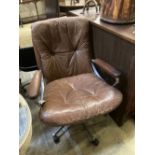 A Norwegian Ring Mekanikk swivel chair upholstered in brown leather