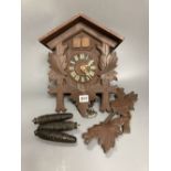 A Black Forest carved cedar cuckoo clock
