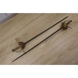 A pair of duelling swords, with cast hilts and 35 inch blades