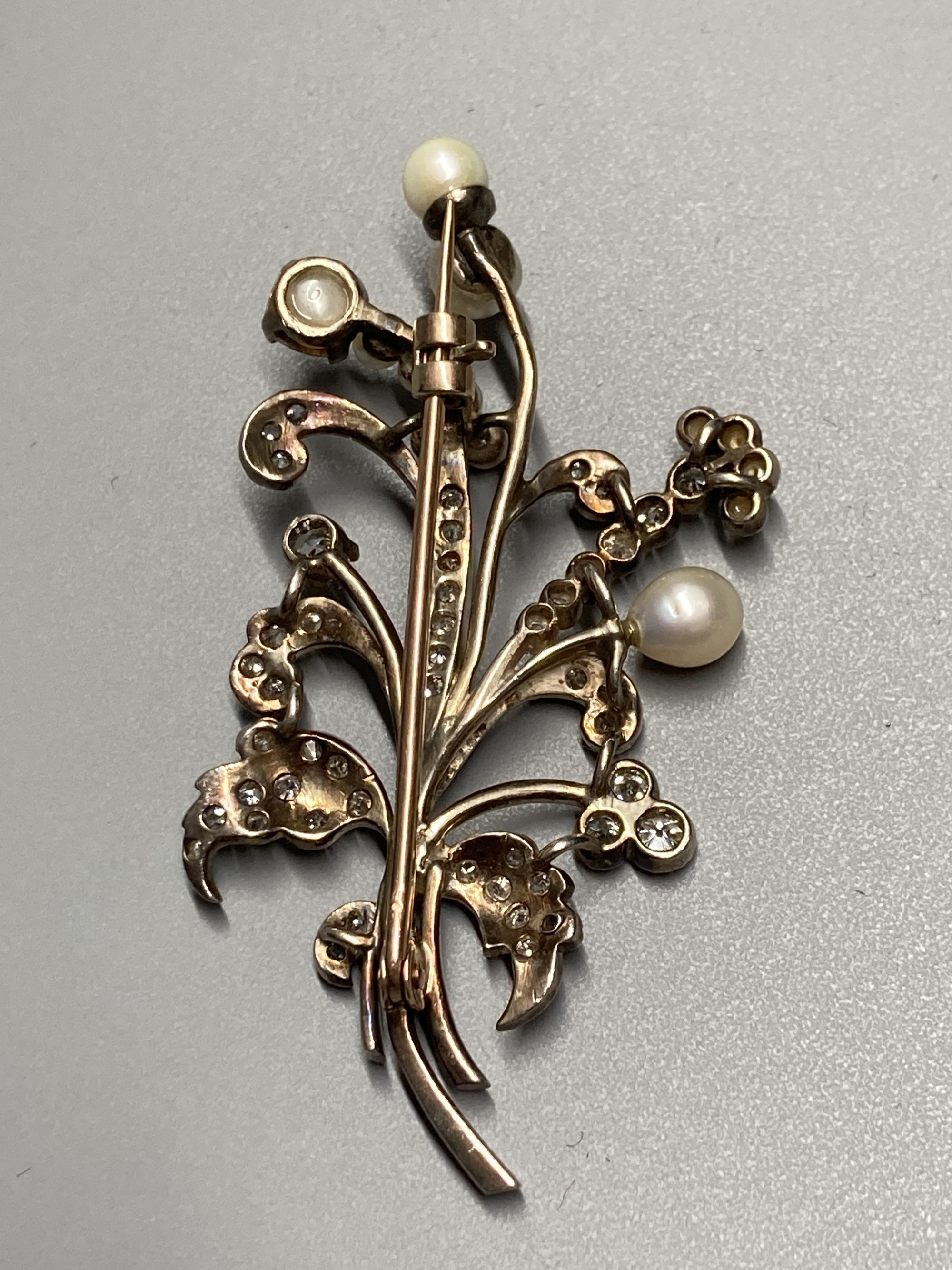 An early 20th century yellow and white metal, cultured pearl and diamond set floral spray brooch, - Image 3 of 3