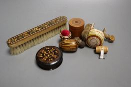 Four Tunbridgeware needlework accessories, a Tunbridgeware clothes brush, a miniature measure, a