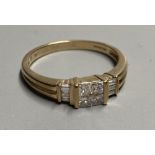 A modern 9ct gold and four stone princess cut diamond cluster ring, with six stone baguette cut