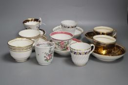 A pair of Miles Mason blue and gilt teacups and saucer, a documentary London handle cup and saucer