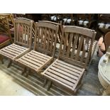 A set of six teak folding garden chairs