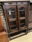 A 1920's oak two door glazed bookcase, width 92cm depth 30cm height 140cm