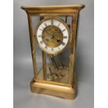 A French brass four glass mantel clock, retailed by J W Benson, with visible Brocot escapement and