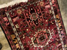 A Persian woollen red ground runner, 300 x 78cm