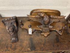 A carved oak eagle hanging coat rack, width 60cm, together with a carved walnut corbel, height 26cm