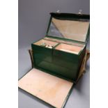 A 1930's ladies green leather travelling toilet case, fittings include seven glass and enamelled