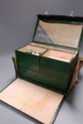 A 1930's ladies green leather travelling toilet case, fittings include seven glass and enamelled