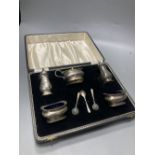 A late 1950's cased silver five piece condiment set, with three spoons, Birmingham, 1957.
