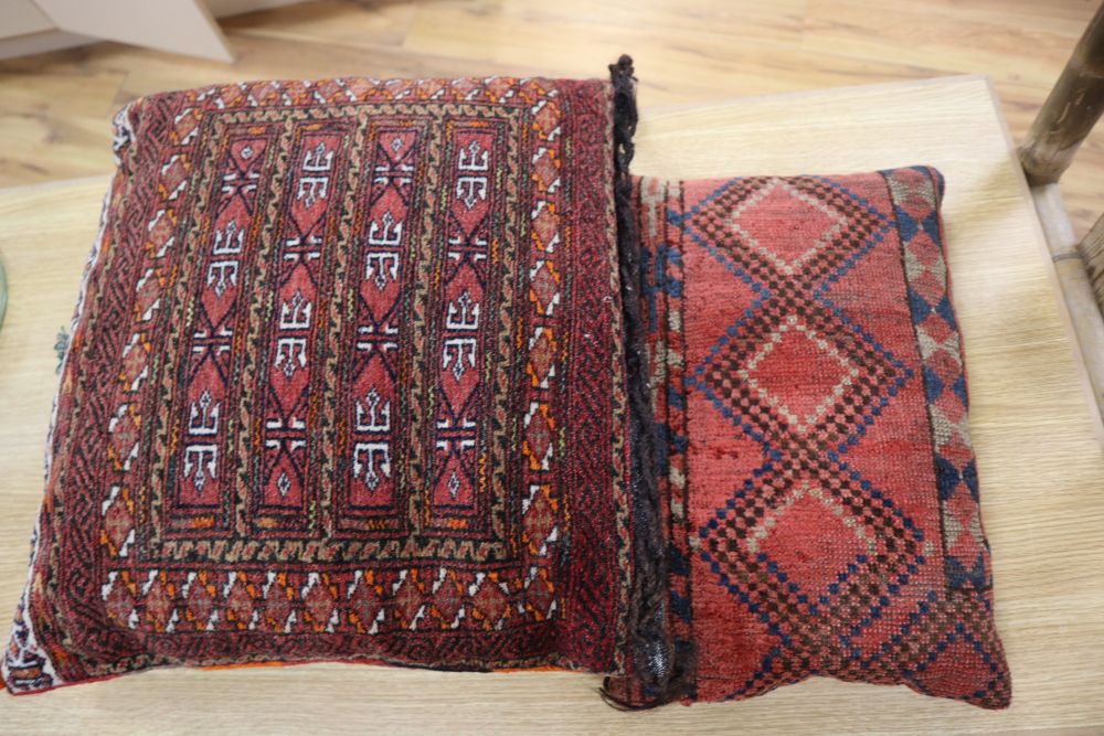 Three carpet cushions, pair 46 x 43cm, single 43 x 28cm