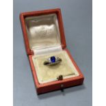 An 18ct, single stone sapphire and six stone diamond cluster ring, size U, gross 3.9 grams, with