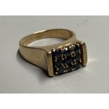 A mid to late 20th century 9ct and nine stone sapphire square cluster ring, size L, gross 5.6