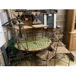 An iron framed circular tiled top table, a set of six iron framed chairs, with rope work seats and a
