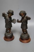 A pair of patinated spelter figures of The Arts, on turned wood plinths, 23.5cm