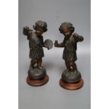 A pair of patinated spelter figures of The Arts, on turned wood plinths, 23.5cm