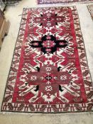 A Kazak red ground rug, 180 x 105cm