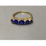 An 18ct and plat. graduated five blue stone doublet half hoop ring, size L, gross 3.1 grams.