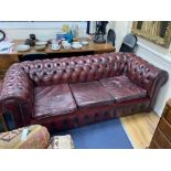 A Victorian style buttoned burgundy leather three seater Chesterfield settee, width 190cm depth 85cm