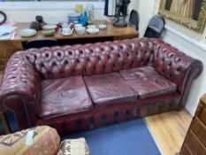 A Victorian style buttoned burgundy leather three seater Chesterfield settee, width 190cm depth 85cm