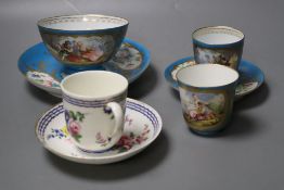 A Sevres coffee cup and saucer painted with flowers under three blue line wrapped in gold, crossed