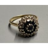 A modern 18ct gold, sapphire and diamond cluster dress ring, size K, gross 5.2 grams.CONDITION: