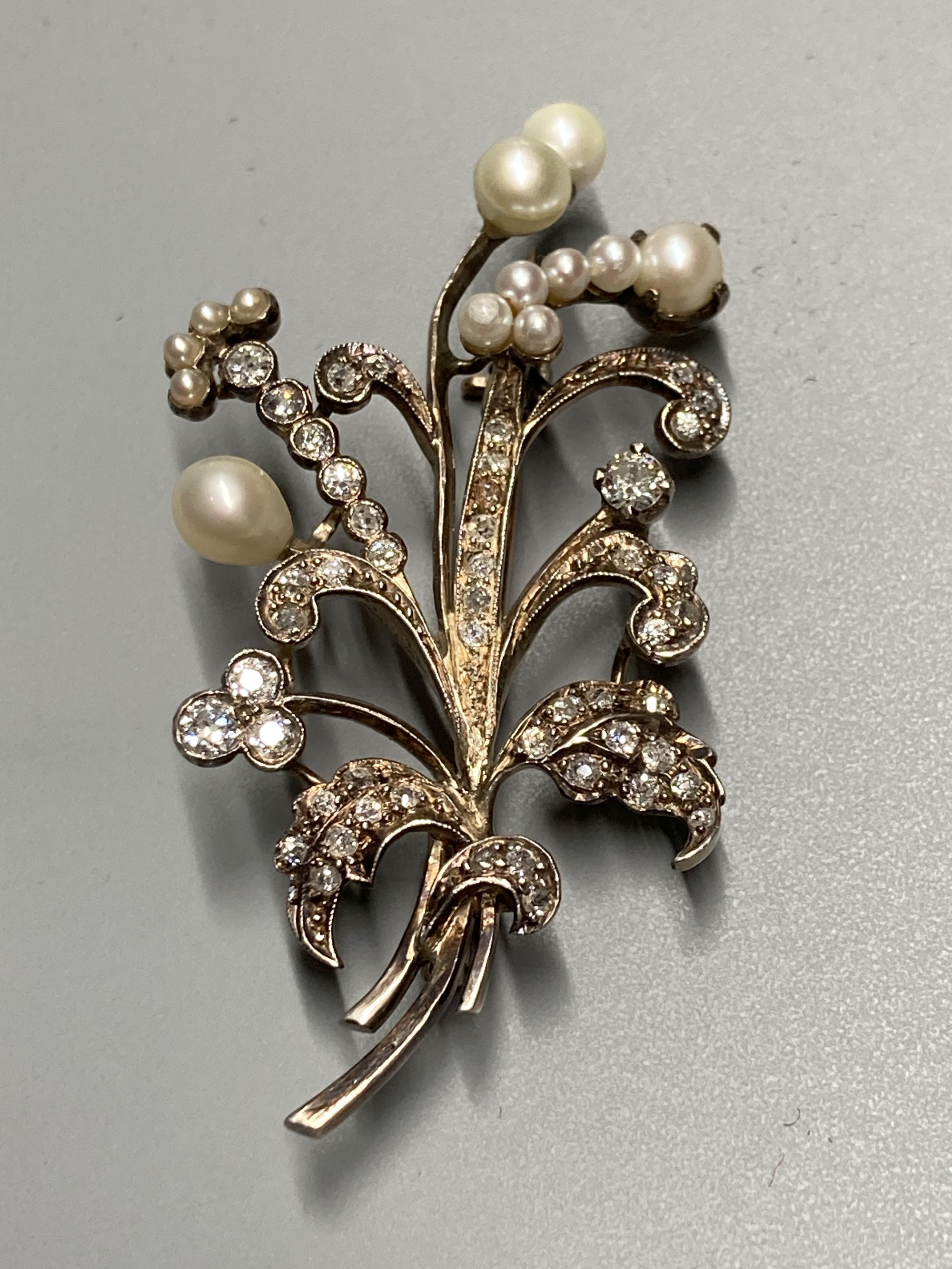An early 20th century yellow and white metal, cultured pearl and diamond set floral spray brooch, - Image 2 of 3