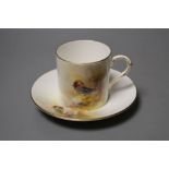 A Royal Worcester coffee can and saucer painted with game birds by P. Platts, signed, date code