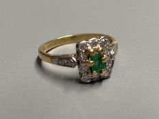 A modern 18ct gold, emerald and diamond rectangular cluster ring, with diamond set shoulders, size