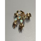A modern 9ct gold and three stone white opal set foliate brooch, 32mm, gross 5.7 grams.CONDITION: