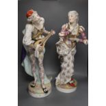 A pair of large 19th century Paris porcelain figures of a mandolin player and a woman dancer,