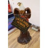 A carved and painted wood model of a Bald Eagle perched on a tree stump and a carved and painted