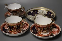 A Spode Dollar pattern two handled cup and saucer, two teacups and saucer and a saucer dish in a