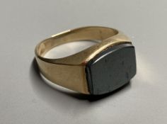 A modern 10k yellow metal and hematite set signet ring, size Q, gross 5.8 grams.CONDITION: Minor