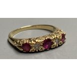 An 18ct Victorian style two stone diamond and three stone ruby set half hoop ring, size K/L. gross