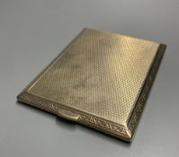 A late 1920's 9ct gold engine-turned cigarette case, with chased fleur-de-lys border, inscribed to