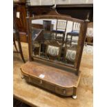 A George III mahogany and tulipwood banded bowfronted toilet mirror, on ivory ball feet, width
